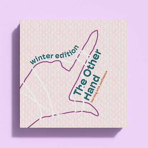 Front cover of left handed pattern book. Shows yarn wrapping around a hand in the L symbol as well as the title and winter edition.