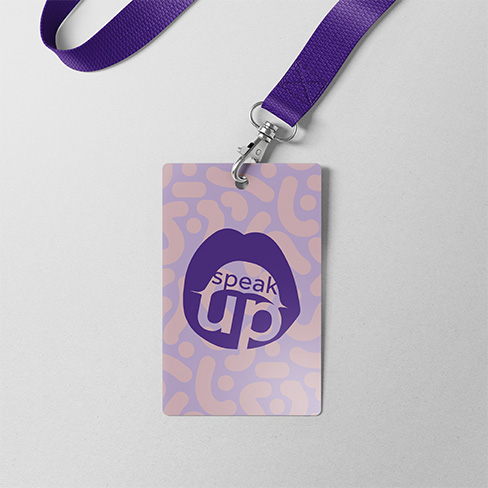 An ID lanyard card laying down with a plain background. ID card says speak up start healing with a simple illustration of an open mouth.